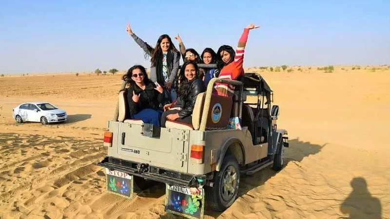 Traveler warming up and stretching near sand dunes in Egypt before starting a desert adventure.