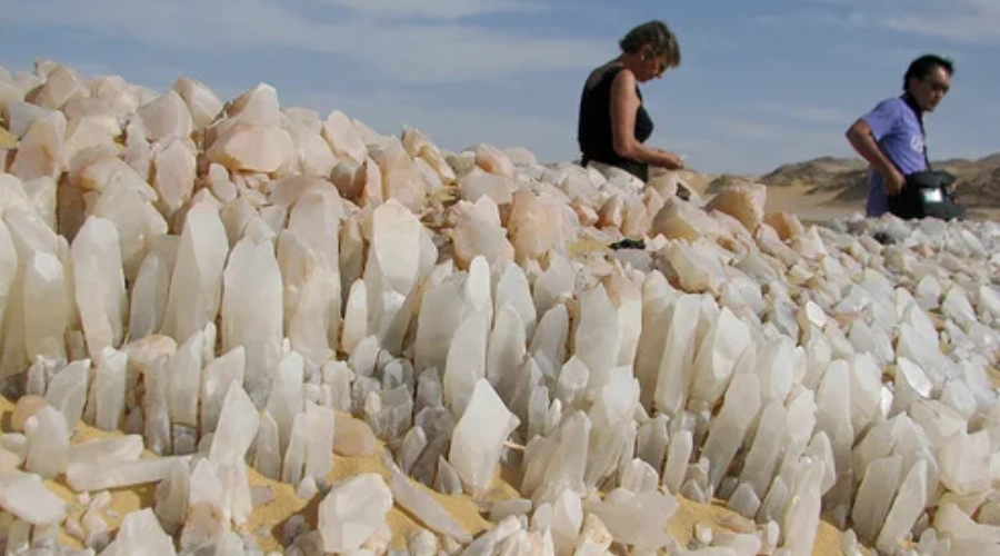 4x4 vehicle driving across rocky terrain near Crystal Mountain in Egypt’s Western Desert during a guided Heart Egypt Tours excursion.