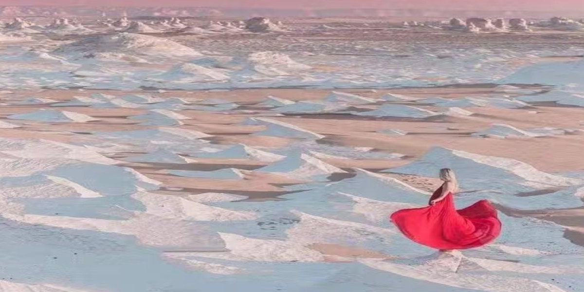 Photographer taking sunrise and sunset photos in Egypt’s White Desert with glowing chalk formations under golden desert light.
