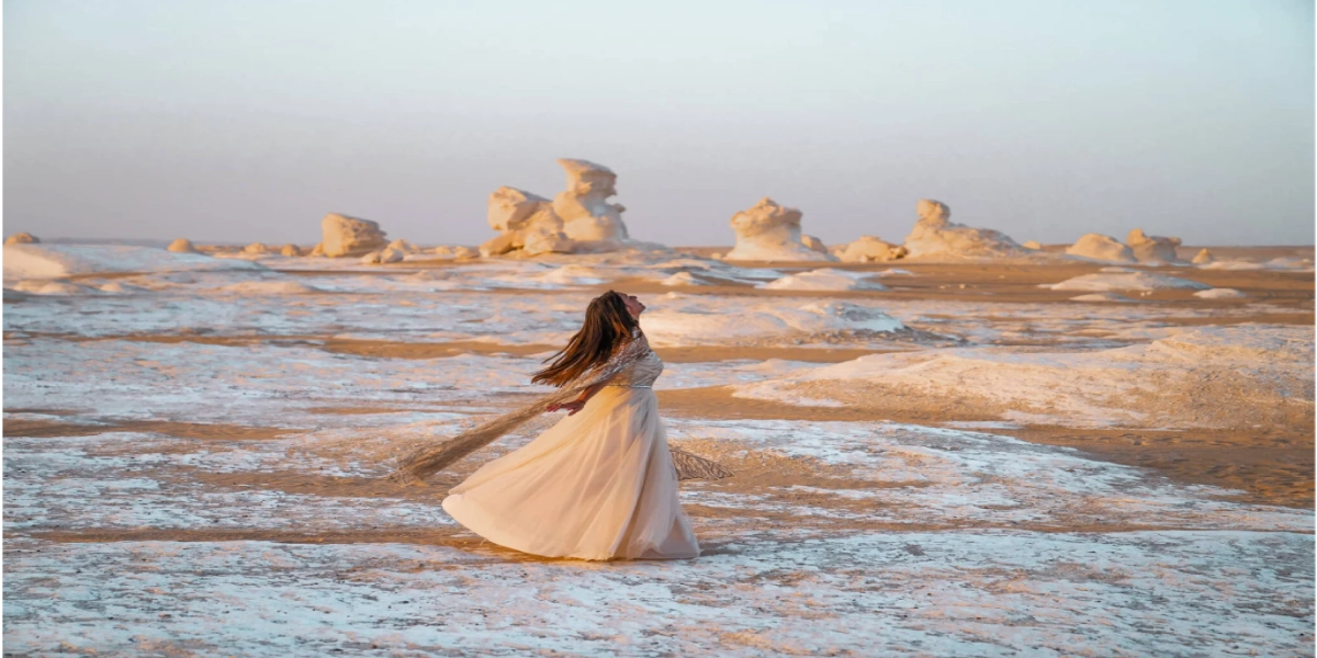 White Desert chalk formations at sunset in Egypt, with travelers exploring the unique landscapes on a Heart Egypt Tours adventure.